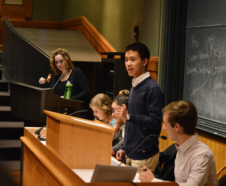 Students presenting at a podium